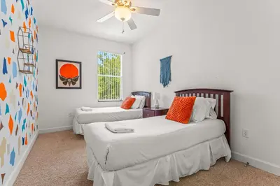 a bedroom with two beds and a ceiling fan at Family Friendly Relax Villa in Kissimmee