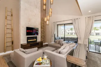 a living room with couches and a fireplace at Villa at Magic Village Resort with Outdoor Oasis in Orlando