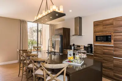 a kitchen with a table and chairs in a kitchen at Villa at Magic Village Resort with Outdoor Oasis in Orlando