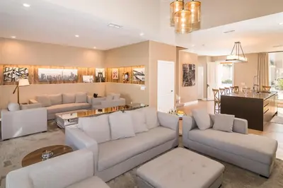a living room with white couches and a dining room at Villa at Magic Village Resort with Outdoor Oasis in Orlando