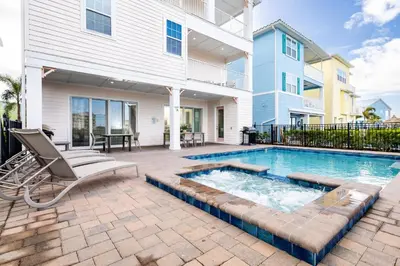 a swimming pool in front of a house at Formosa Mimosa - Margaritaville in Orlando