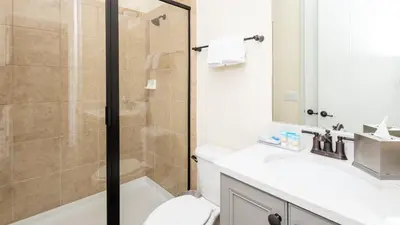 a bathroom with a shower and a toilet and a sink at Formosa Mimosa - Margaritaville in Orlando