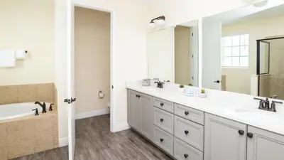 a bathroom with two sinks and a large mirror at Formosa Mimosa - Margaritaville in Orlando