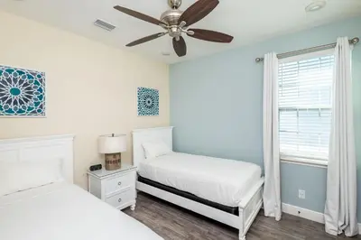 a bedroom with two beds and a ceiling fan at Formosa Mimosa - Margaritaville in Orlando