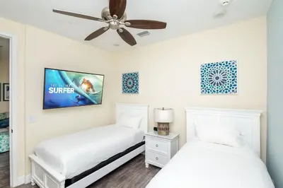 two beds in a bedroom with a ceiling fan at Formosa Mimosa - Margaritaville in Orlando