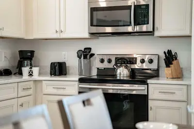 a kitchen with a stove and a microwave at Frankly Fintastic - Happy Days in Orlando