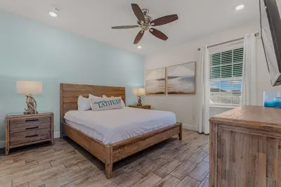 a bedroom with a bed and a ceiling fan at Frankly Fintastic - Happy Days in Orlando