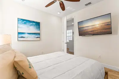 a bedroom with a bed and a ceiling fan at Frankly Fintastic - Happy Days in Orlando