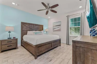 a bedroom with a bed and a ceiling fan at Frankly Fintastic - Happy Days in Orlando