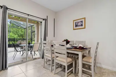 a dining room with a table and chairs at Veranda Sunshine Escape - 5 BDR in Kissimmee