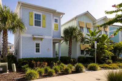 a house with yellow shutters and palm trees at Up to Scale With Margaritas in Orlando
