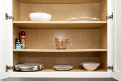 a cupboard with plates and bowls and a blender at Up to Scale With Margaritas in Orlando