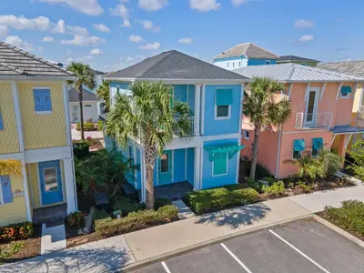 a row of houses with palm trees in a parking lot at Get Happy in Orlando