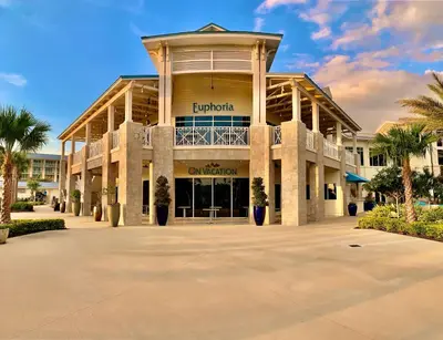 a large building with palm trees in front of it at Get Happy in Orlando