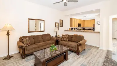 a living room with two couches and a table at Tranquil Breeze at Caribe Cove in Orlando