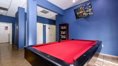a billiard room with a red pool table at Tranquil Breeze at Caribe Cove in Orlando