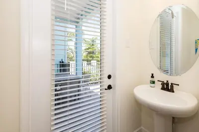a bathroom with a sink and a window with blinds at Hunky Dory II in Orlando