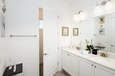 a white bathroom with two sinks and a mirror at Trade Winds Life - Margaritaville in Orlando