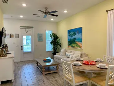a living room with a table and a couch at Krows Nest - Near Disney World & Universal in Orlando