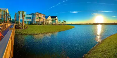 a view of a river with houses and palm trees at Lafitte's Landing Lakeview Cottage - Lakefront in Orlando
