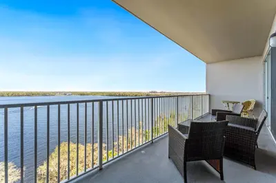 a balcony with chairs and a view of the water at Lake Views At Blue Heron in Orlando