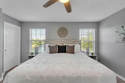 a bedroom with a large bed with a ceiling fan at Create Lasting Magical Memories Resort Home for 8 in Kissimmee