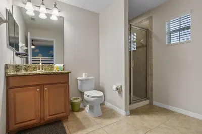 a bathroom with a toilet and a shower and a sink at Main Street Gem in Paradise Palms Resort in Kissimmee