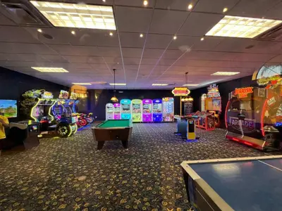 a room with several arcade games and a pool table at Main Street Gem in Paradise Palms Resort in Kissimmee