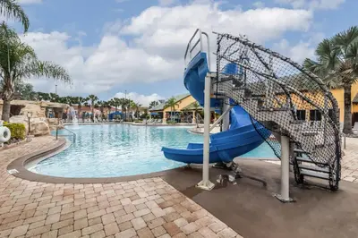 a water slide in a pool at a resort at Main Street Gem in Paradise Palms Resort in Kissimmee