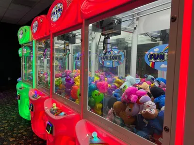 a group of arcade machines filled with stuffed animals at Main Street Gem in Paradise Palms Resort in Kissimmee