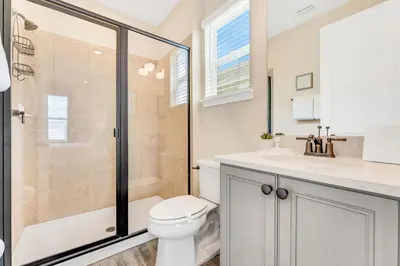 a bathroom with a shower and a toilet and a sink at The Sea Shelter - Sunny 4 BDR in Margaritaville in Orlando
