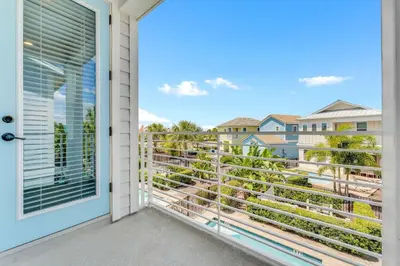 a door to a balcony with a view at The Sea Shelter - Sunny 4 BDR in Margaritaville in Orlando
