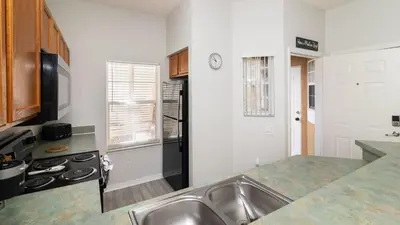 a kitchen with a sink and a stove at The Emerald Cove - Best Spot in Kissimmee in Kissimmee