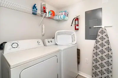 a laundry room with a washer and dryer at The Emerald Cove - Best Spot in Kissimmee in Kissimmee
