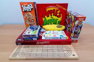 a pile of games and a computer keyboard on a table at The Emerald Cove - Best Spot in Kissimmee in Kissimmee
