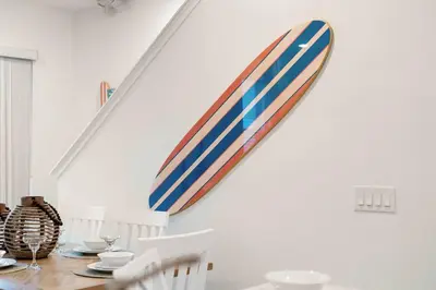 a surfboard hanging on a wall in a dining room at Mint to Be in Orlando