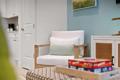 a living room with a chair and a table at Mint to Be in Orlando