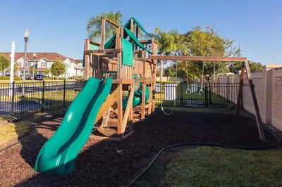 a playground with a slide in a park at Moana's Hut - Miles from World's Best Theme Parks in Kissimmee