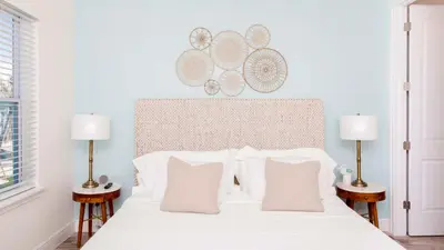 a bedroom with a white bed with two lamps at No Way Rose - Nearby Disney World & Universal in Orlando