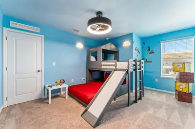 a childs bedroom with a bunk bed and blue walls at Once Upon a Stay in Kissimmee