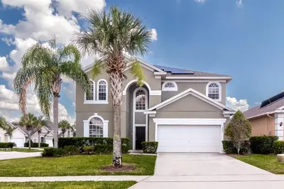 a house with palm trees in front of it at New Ownership - 7BR - close to Disney in Orlando