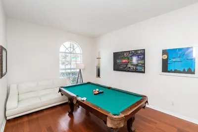 a living room with a pool table and a couch at New Ownership - 7BR - close to Disney in Orlando