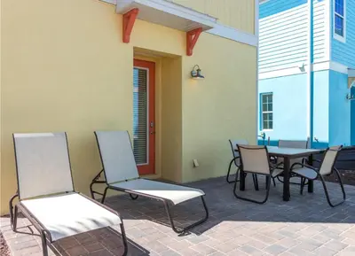 a patio with chairs and a table and a table and chairs at Parrotfish Place - Stay for 6 in Orlando
