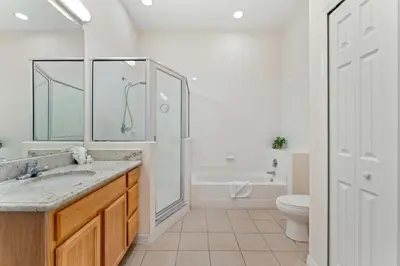 a bathroom with a shower and a sink and a toilet at Peaceful Horizons at Caribe Cove in Kissimmee