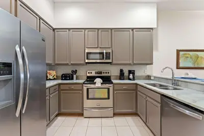 a kitchen with wooden cabinets and stainless steel appliances at Peaceful Horizons at Caribe Cove in Kissimmee