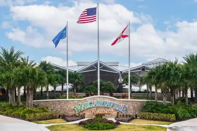 a sign with three flags in front of a building at Pistachio Palace - Sleeps 10 in Orlando