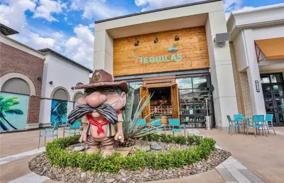 a statue of a person in front of a store at Pistachio Palace - Sleeps 10 in Orlando