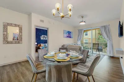 a dining room and living room with a table and chairs at Windsor Hills Resort 2Bd with Great Amenities in Orlando