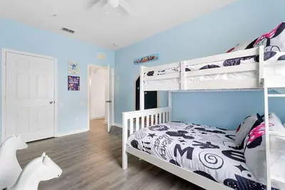 a bedroom with two bunk beds and blue walls at Windsor Hills Resort 2Bd with Great Amenities in Orlando