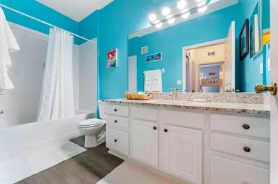 a bathroom with blue walls and a sink and a toilet at Windsor Hills Resort 2Bd with Great Amenities in Orlando
